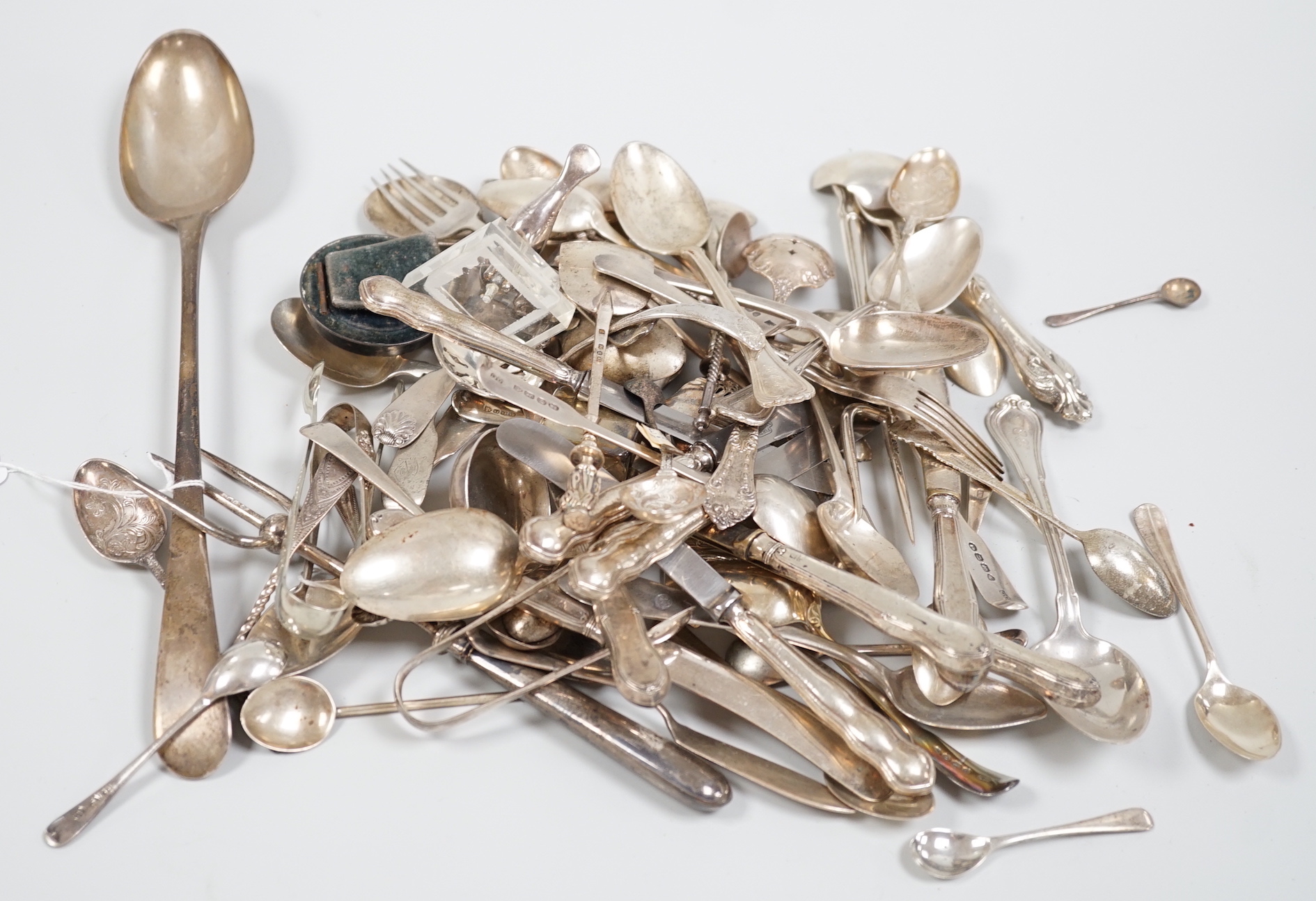 Sundry silver and white metal flatware including a George III silver Old English pattern basting spoon, London, 1782, teaspoons, condiments spoons, sifter spoon, caddy spoon etc.